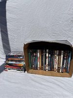 Box of DVDs and separate stack on left