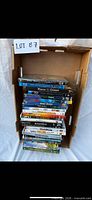 Box of approximately 24 DVDs and Blu-rays showing spines