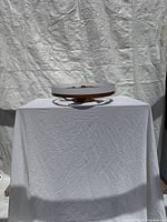 Full view of ceiling fan light on draped table