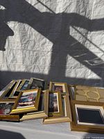 Stack of gold-tone frames laid out showing variety of sizes and styles
