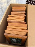 Frames neatly packed in box, front edges visible