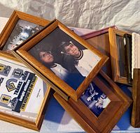 stacked wooden frames with various photos and certificate