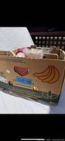 Banana box containing assorted glass and ceramic vases