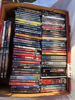 Overhead view of full box showing two rows of DVDs