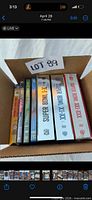 Box containing nine DVD cases with spines visible