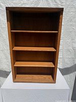 Front view of teak bookcase showing three shelves