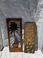 Both wall art pieces standing against backdrop