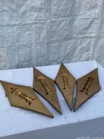 front view of four diamond plaques showing chess pieces