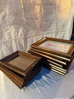 Stack of six smaller and six larger dark wood frames