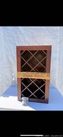 Front view of wood wine rack with lattice grid and hardware bag
