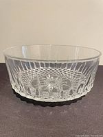Side view of clear pressed glass bowl showing ribbed and diamond pattern