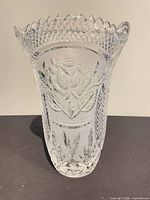 Front view of clear cut crystal vase showing rose motif and scalloped rim