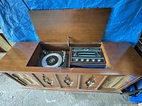 Console stereo with lid open showing Garrard turntable and radio controls