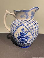 Full left side view of blue and white porcelain pitcher