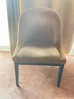 Front view of upholstered chair showing color, seat and legs