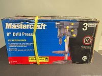 Front of boxed Mastercraft 8" Drill Press showing product image and key specs