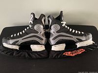 Side view of both skates with blade covers attached