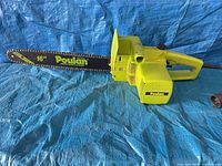 Left side view showing full chainsaw and 16-inch bar