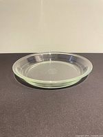Side view of clear Pyrex pie plate showing depth and rim