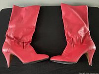 Side profile of both red boots showing shape and heel
