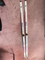 Full view of both 180 cm Rossignol skis showing bindings and graphics