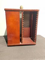 Front view of wooden rotating CD tower showing two slotted sides