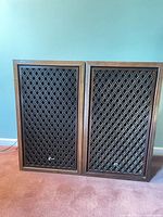 Front view of both Sansui SP-2000 speakers showing lattice grills and wood veneer