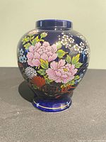 Front view of cobalt blue porcelain vase with floral decoration