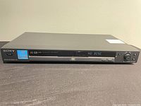 Front view of Sony DVP-NS325 showing disc tray and display