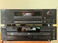 Front view of Sony STR-D311 receiver stacked above Sony CDP-C435 CD changer