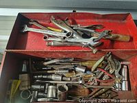 Top tray of toolbox showing Fairmount wrench and other wrenches