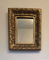 Front view of rectangular gilded mirror showing full frame and mirror