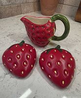 Strawberry pitcher with two wall plaques front angle