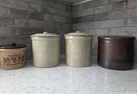 All four crocks together, lids on