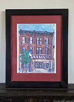 Full view of framed print showing burgundy mat and black frame