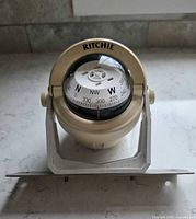 Front view showing compass face, dial, and mount