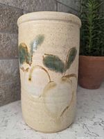 Front view showing apple motif and glaze