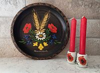 Group shot showing plate and two candle holders with red candles inserted