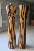 Front view of both zebrawood mills showing grain pattern and metal knob