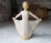 Rear angled view showing gold-accented skirt detail