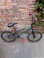 Full right-side view of GT BMX bicycle against brick wall