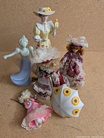 Group shot showing all figurines, dolls and parasol
