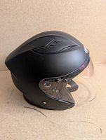Left-rear view of matte black WCL 612 helmet showing shell shape and visor