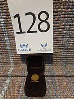 Ring in open velvet box beneath lot number card