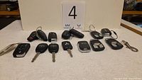 All 13 car keys and fobs laid out