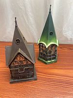 Two gothic house lanterns front view showing finishes and glass panels