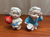 Both Hakata clay child figurines together