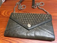 Front view of studded wallet showing studs, flap, logo snap