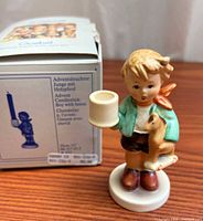 Figurine beside original box showing size and components