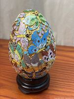 Full view of cloisonné egg on wood stand